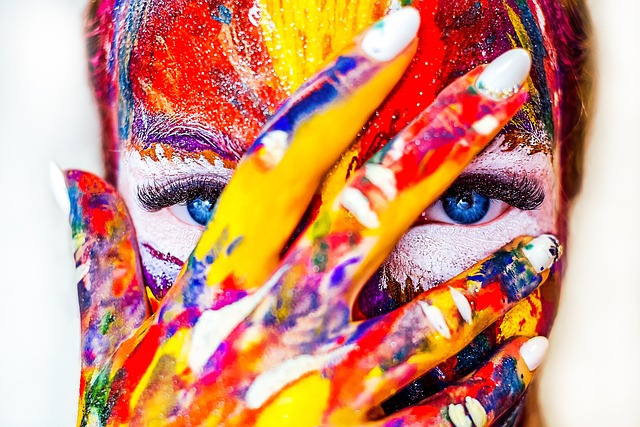 Close-up of a face with vibrant paint colors, symbolizing the role of color psychology in website design and user engagement
